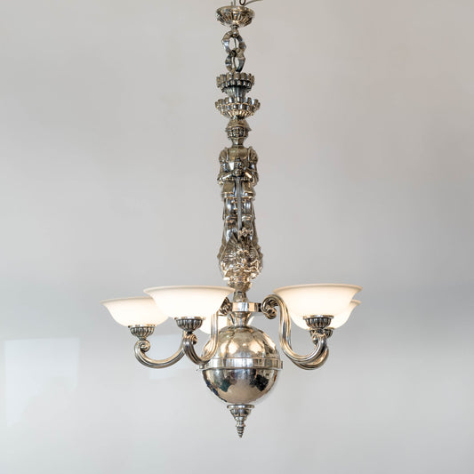 Taklampa i vitmetall, av Per Torndahl för Atelier Torndahl med motivet S:t Göran och draken, 1920-tal. H: 115cm och diam. 70cm. Per Torndahl ceiling light "Staint George and the dragon" for Atelier Torndahl, 1920's. H: 115cm/45,3" and diam. 70cm/27,6"