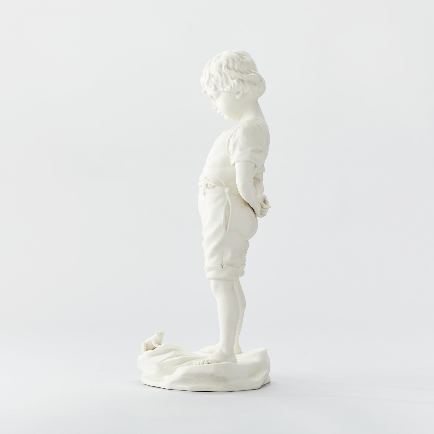 Parianfigurin från Gustavsberg, ”Pojken och Grodan”. 51cm hög. Märkt Gustavsberg och tillverkningsåret 04. Parian figurine, ”Boy and the Frog” by Gustavsberg. H: 51cm/20,1″. Marked Gustavsberg 04.
