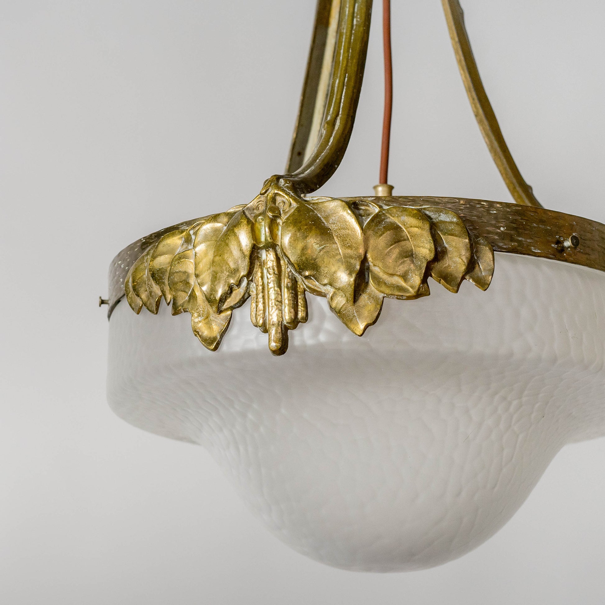 Jugendtaklampa i guldpatinerad brons från Böhlmarks, 1910-tal. 80cm hög och diam. 40cm. An art nouveau ceiling light in bronze. Made by Böhlmarks around 1910. H: 80cm/31,5″ and diam. 40cm/15,7″