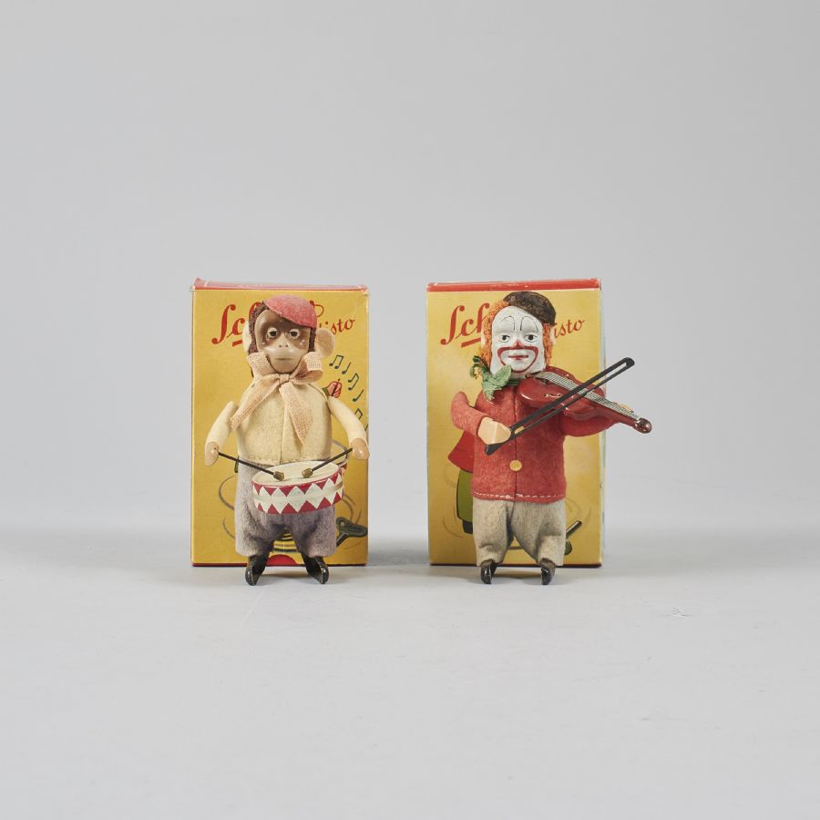 Schuco trummande apa och fiolspelande clown inklusive originalkartong. Pris: 2600 kr/st. Schuco drummer monkey and clown violinist. Made in U.S.-Zone Germany. Price: 2600/each.